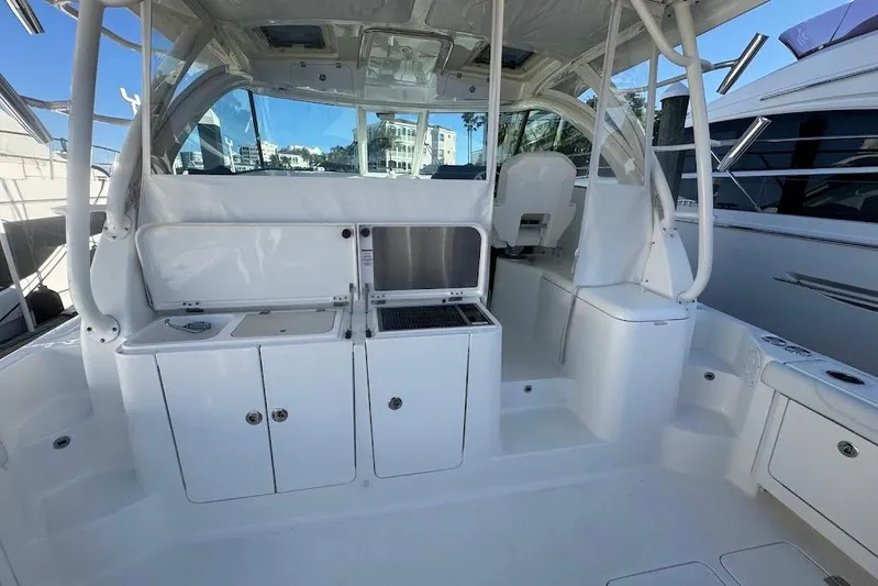  Yacht Photos Pics 2021 Pursuit OS 385 Offshore boat interior with white cabinetry and seating.