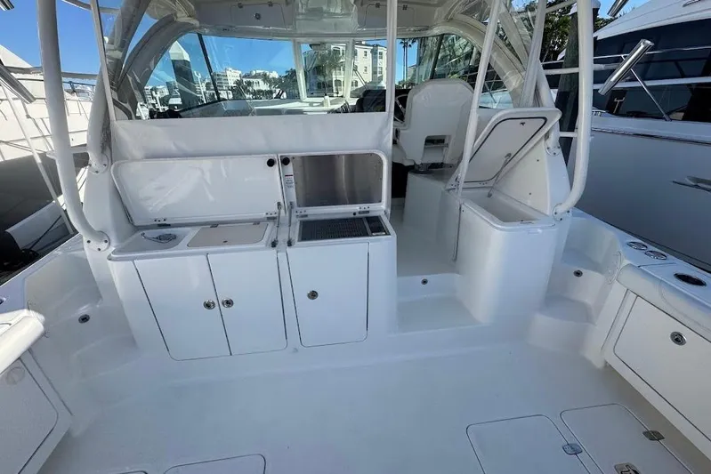  Yacht Photos Pics 2021 Pursuit OS 385 Offshore boat interior with seating and storage compartments.