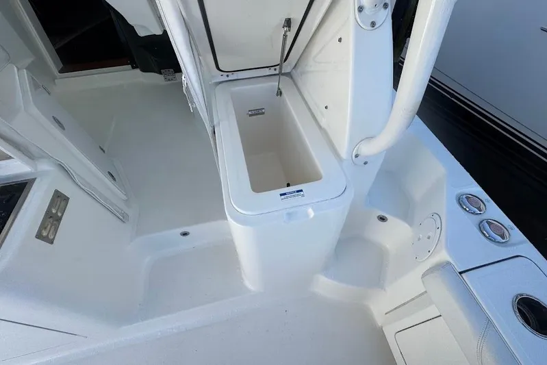  Yacht Photos Pics 2021 Pursuit OS 385 Offshore boat interior with open storage compartment.