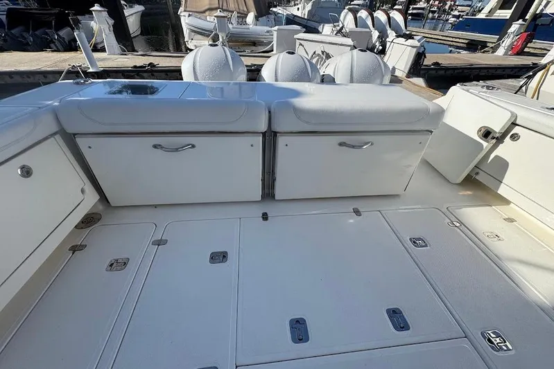  Yacht Photos Pics 2021 Pursuit OS 385 Offshore boat deck with storage compartments and seating.