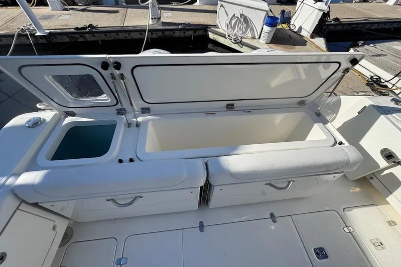  Yacht Photos Pics 2021 Pursuit OS 385 Offshore boat with open storage compartments at the dock.