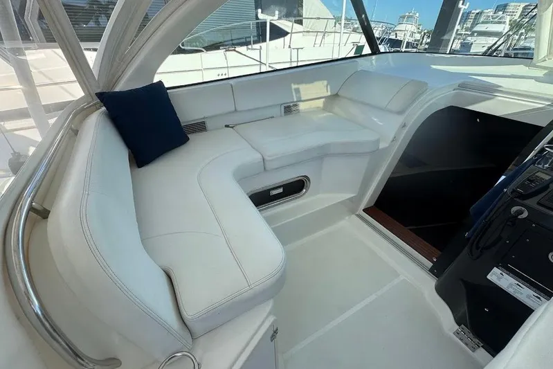  Yacht Photos Pics 2021 Pursuit OS 385 Offshore boat interior with white seating and blue cushion.