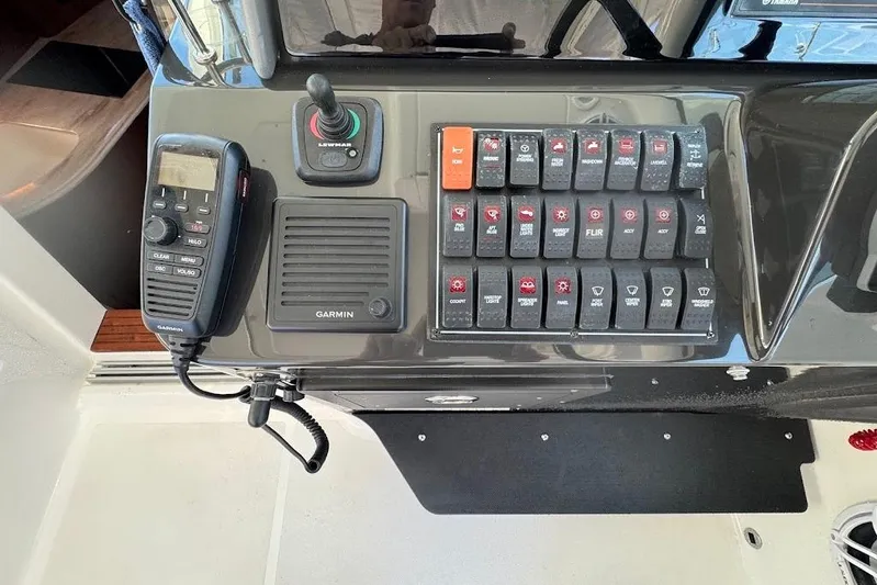  Yacht Photos Pics Control panel of 2021 Pursuit OS 385 Offshore boat with Garmin radio and switches.
