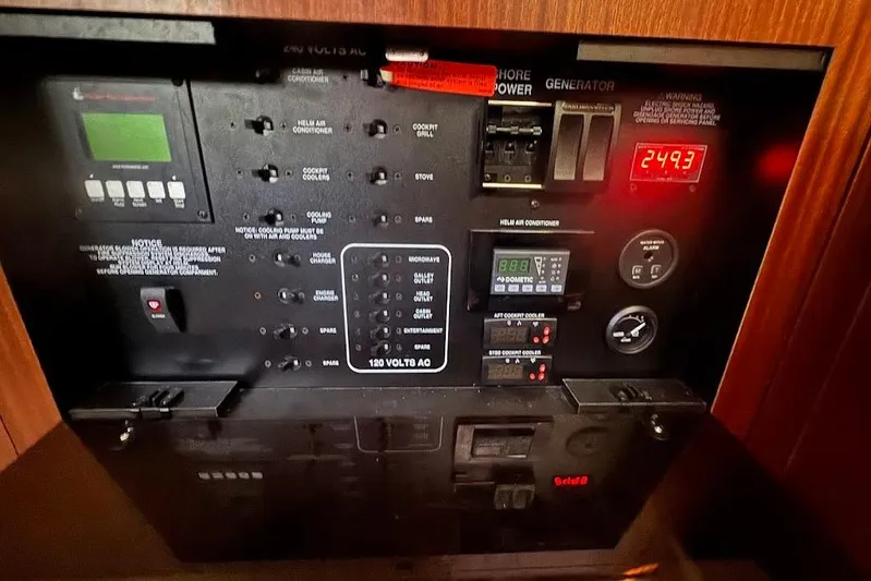  Yacht Photos Pics Electrical control panel of a 2021 Pursuit OS 385 Offshore boat, displaying various switches and gauges.
