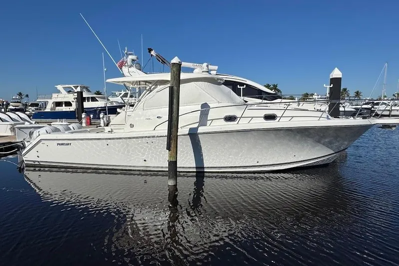  Yacht Photos Pics 2021 Pursuit OS 385 Offshore boat docked in a marina under clear blue skies.