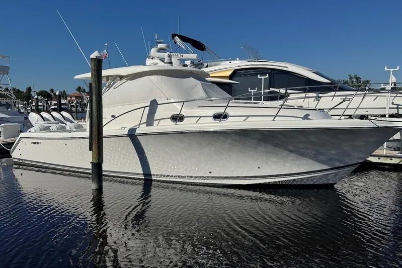  Yacht Photos Pics 2021 Pursuit OS 385 Offshore boat docked in marina under clear blue sky.