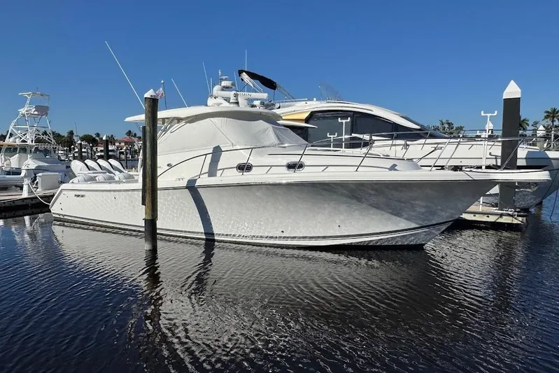  Yacht Photos Pics 2021 Pursuit OS 385 Offshore boat docked in marina under clear blue sky.