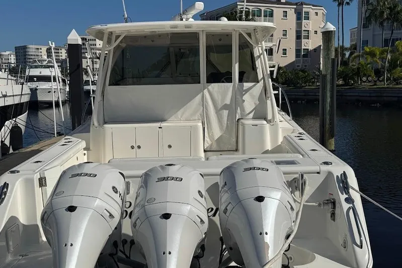 Yacht Photos Pics 2021 Pursuit OS 385 Offshore boat with triple 300 horsepower engines docked at marina.
