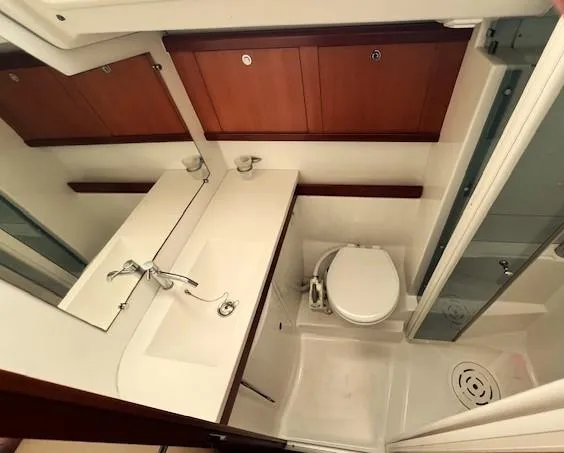 Lotus II Yacht Photos Pics Bathroom interior of 2007 Beneteau Oceanis 46 yacht, featuring sink, toilet, and shower.
