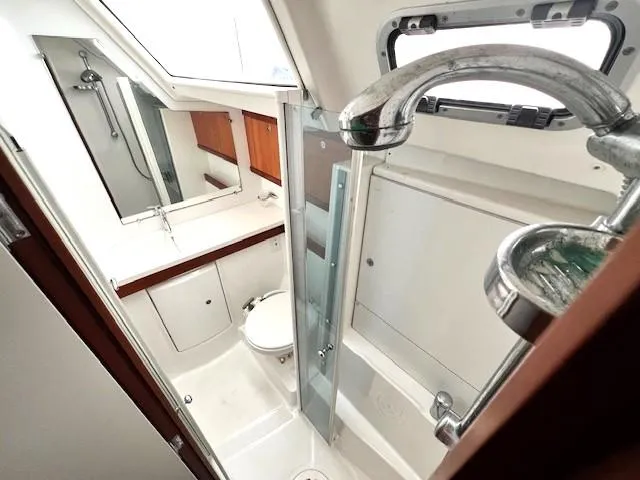 Lotus II Yacht Photos Pics Bathroom interior of 2007 Beneteau Oceanis 46 yacht, featuring shower and sink.