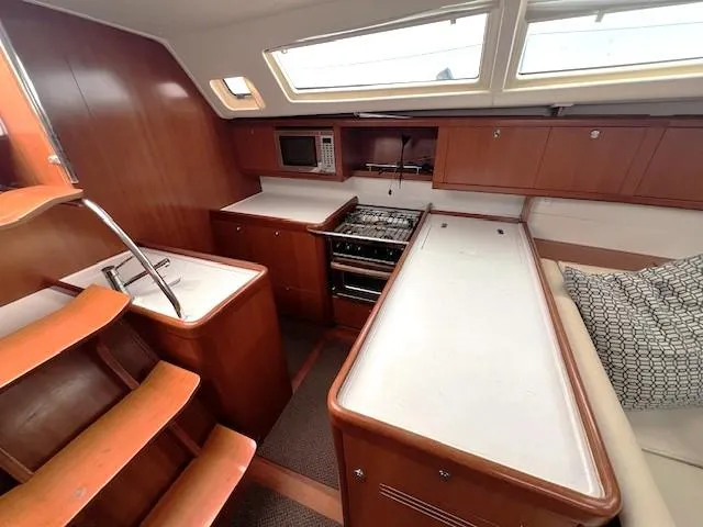Lotus II Yacht Photos Pics Interior of 2007 Beneteau Oceanis 46 yacht with modern kitchen and wooden cabinetry.