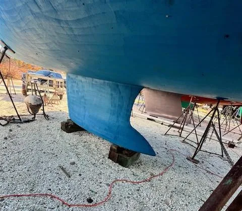 Lotus II Yacht Photos Pics Blue hull of a 2007 Beneteau Oceanis 46 sailboat on stands.