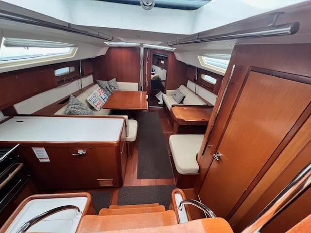 Lotus II Yacht Photos Pics Interior of 2007 Beneteau Oceanis 46 sailboat with wood finish and cozy seating area.