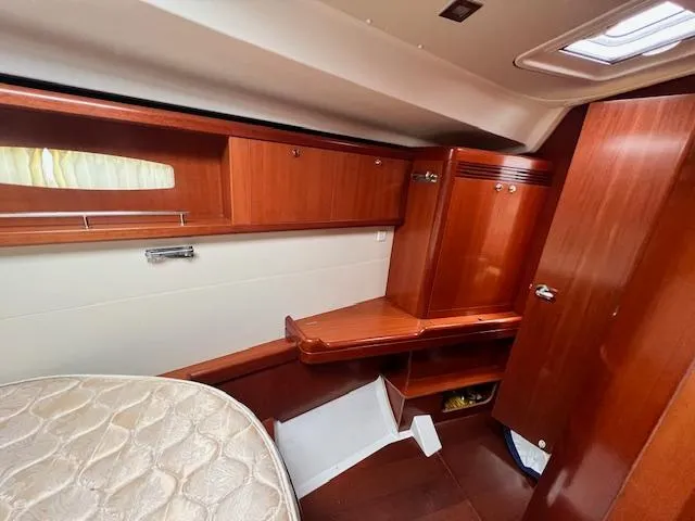 Lotus II Yacht Photos Pics Interior cabin of 2007 Beneteau Oceanis 46 yacht with wooden furnishings and storage.