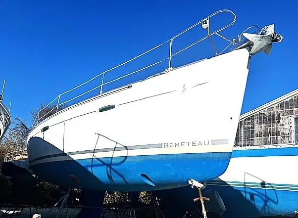 Lotus II Yacht Photos Pics 2007 Beneteau Oceanis 46 sailboat on land, white hull, blue bottom, clear sky background.