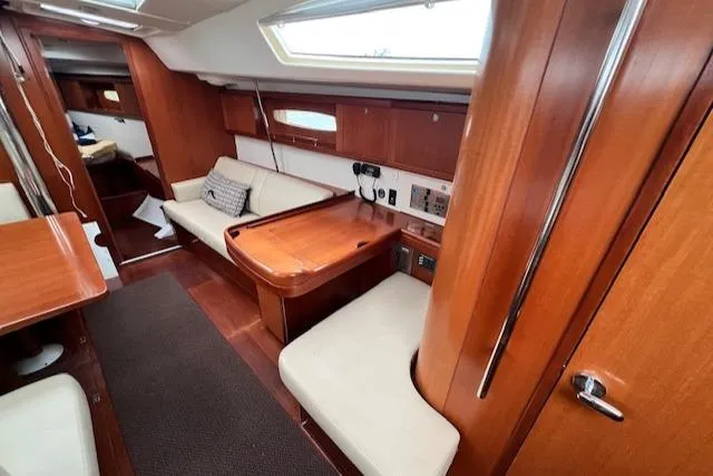 Lotus II Yacht Photos Pics Interior of 2007 Beneteau Oceanis 46 sailboat with wooden furnishings and seating area.