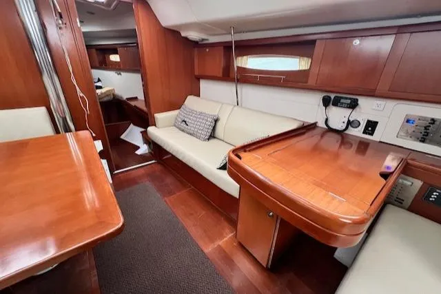 Lotus II Yacht Photos Pics Interior of 2007 Beneteau Oceanis 46 yacht with wooden furnishings and cozy seating area.