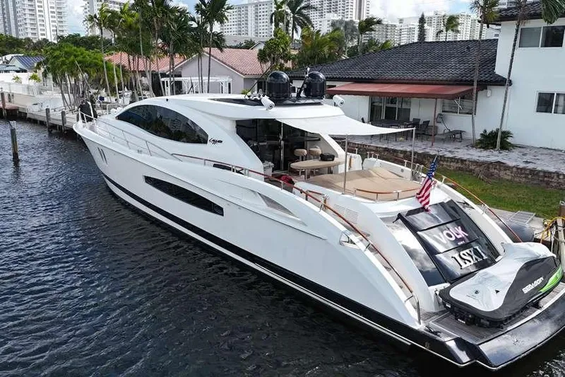  Yacht Photos Pics Luxury 2009 Lazzara LSX 75 yacht docked by waterfront homes, featuring sleek design and spacious deck.