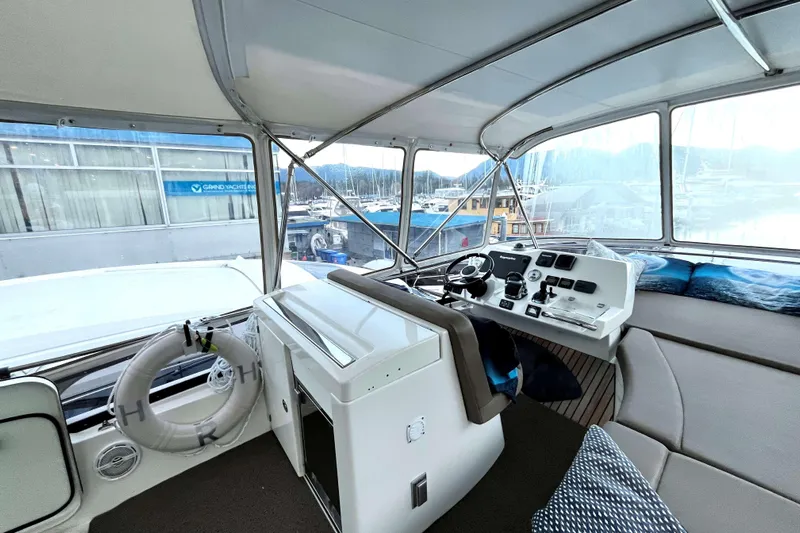  Yacht Photos Pics Interior view of a 2014 Prestige 500 yacht cockpit with navigation controls and seating.