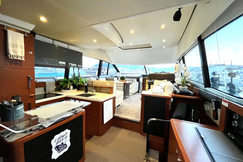  Yacht Photos Pics Luxurious interior of a 2014 Prestige 500 yacht with modern kitchen and seating area.