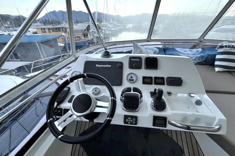  Yacht Photos Pics Cockpit of 2014 Prestige 500 yacht with steering wheel and navigation controls.