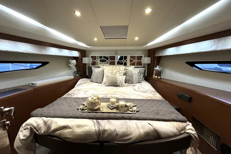  Yacht Photos Pics Luxurious bedroom interior of 2014 Prestige 500 yacht with elegant bedding and ambient lighting.