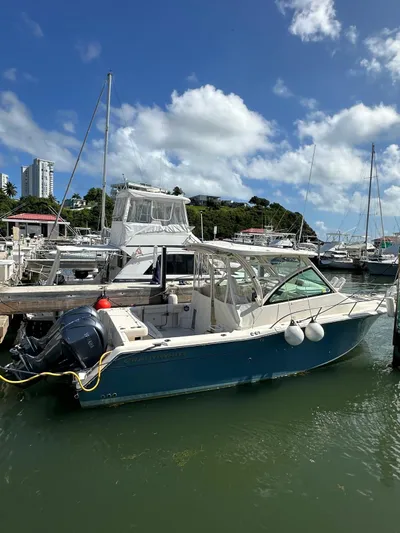  Yacht Photos Pics 2022 Grady-White Express 330 boat docked in marina under blue sky.