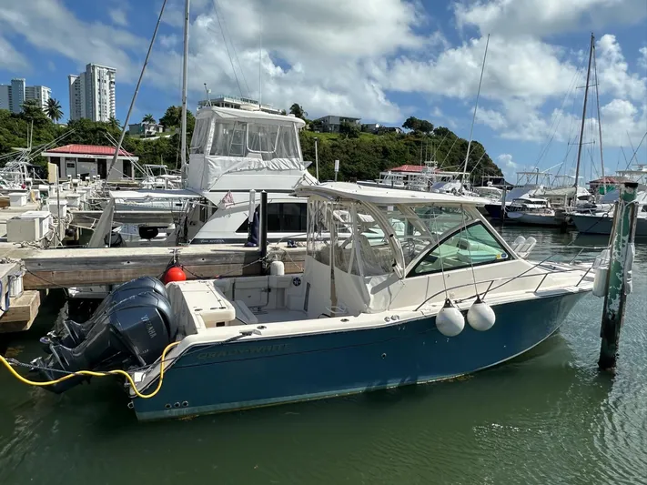  Yacht Photos Pics 2022 Grady-White Express 330 boat docked in marina under blue sky.