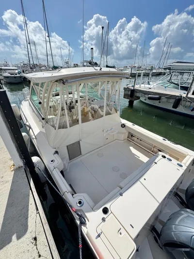 Yacht Photos Pics 2022 Grady-White Express 330 boat docked at marina under blue sky.