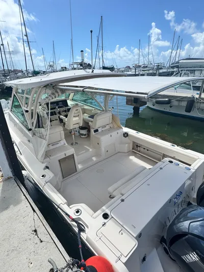  Yacht Photos Pics 2022 Grady-White Express 330 boat docked at marina under clear blue sky.