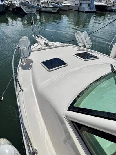  Yacht Photos Pics 2022 Grady-White Express 330 boat docked in marina, showcasing sleek design and spacious deck.