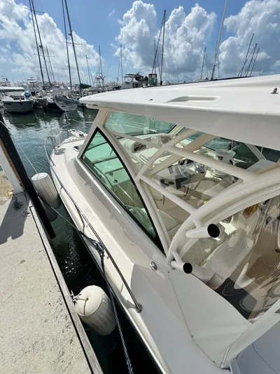  Yacht Photos Pics 2022 Grady-White Express 330 boat docked at marina under blue sky.