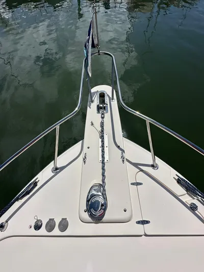  Yacht Photos Pics 2022 Grady-White Express 330 boat bow with anchor chain on calm water.