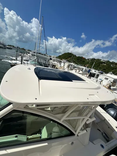  Yacht Photos Pics 2022 Grady-White Express 330 boat docked at marina under clear skies.