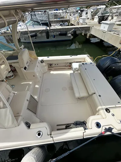  Yacht Photos Pics 2022 Grady-White Express 330 boat docked, spacious deck, dual engines visible.