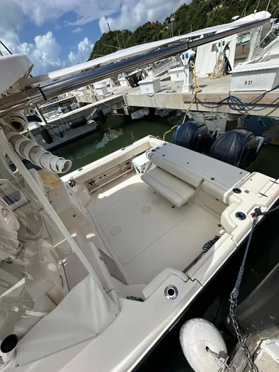  Yacht Photos Pics 2022 Grady-White Express 330 boat docked, featuring spacious deck and dual outboard engines.
