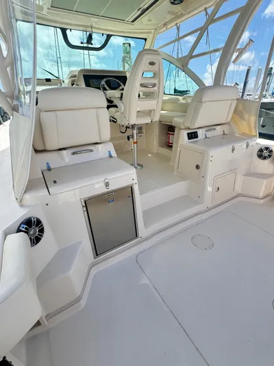  Yacht Photos Pics 2022 Grady-White Express 330 boat interior with white seating and modern controls.