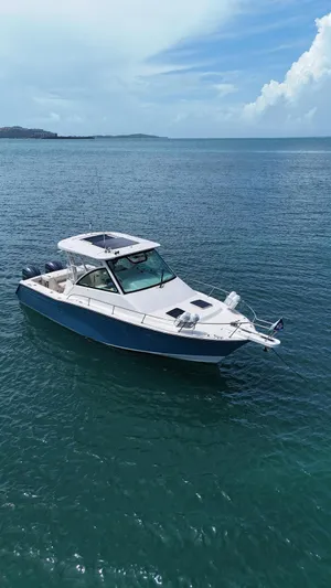  Yacht Photos Pics 2022 Grady-White Express 330 boat on calm ocean waters under a clear sky.