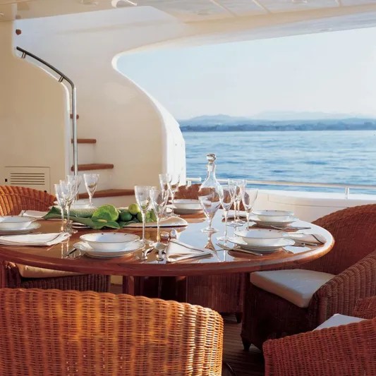 Nm03008 Yacht Photos Pics Luxurious dining setup on 2008 Ferretti Yachts 881, overlooking serene ocean view.
