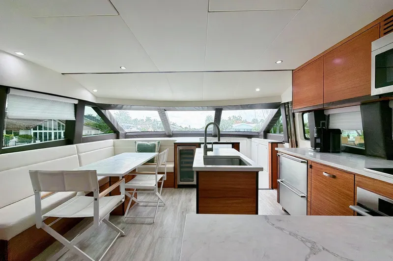 2024 Refit Yacht Photos Pics Luxurious interior of 2011 Hatteras 60 Motor Yacht with modern kitchen and dining area.