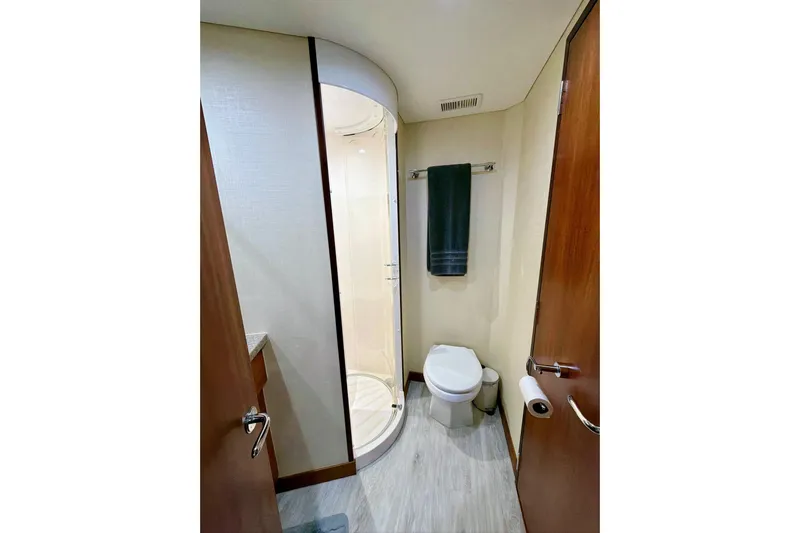 2024 Refit Yacht Photos Pics Bathroom interior of 2011 Hatteras 60 Motor Yacht with shower and toilet.