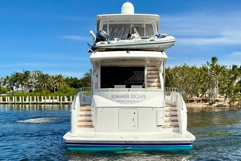 2024 Refit Yacht Photos Pics 2011 Hatteras 60 Motor Yacht on water, rear view, with tender on top.