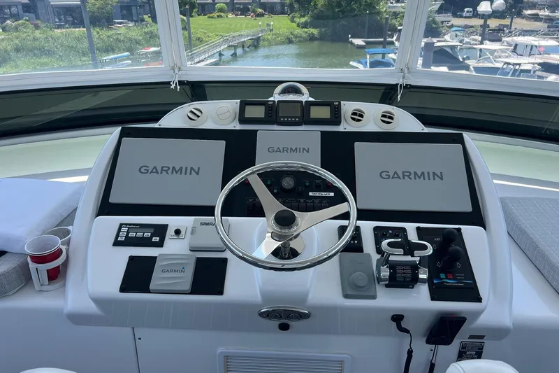 2024 Refit Yacht Photos Pics Helm of 2011 Hatteras boat with Garmin navigation displays and controls.