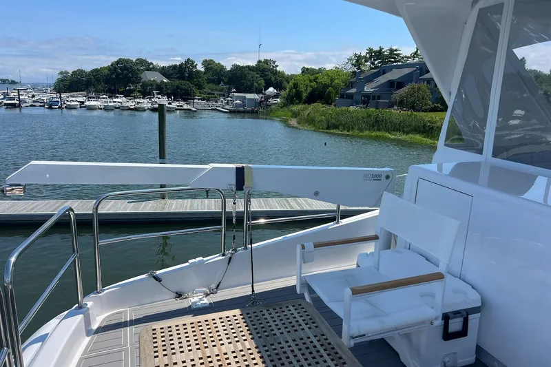 2024 Refit Yacht Photos Pics 2011 Hatteras yacht deck with seating, overlooking marina and waterfront homes.