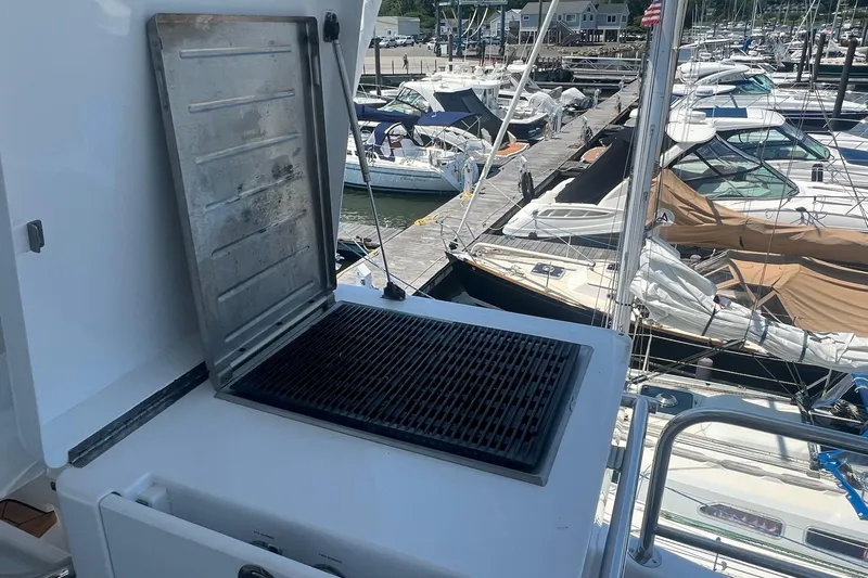 2024 Refit Yacht Photos Pics Outdoor grill on a 2011 Hatteras yacht docked at a marina.