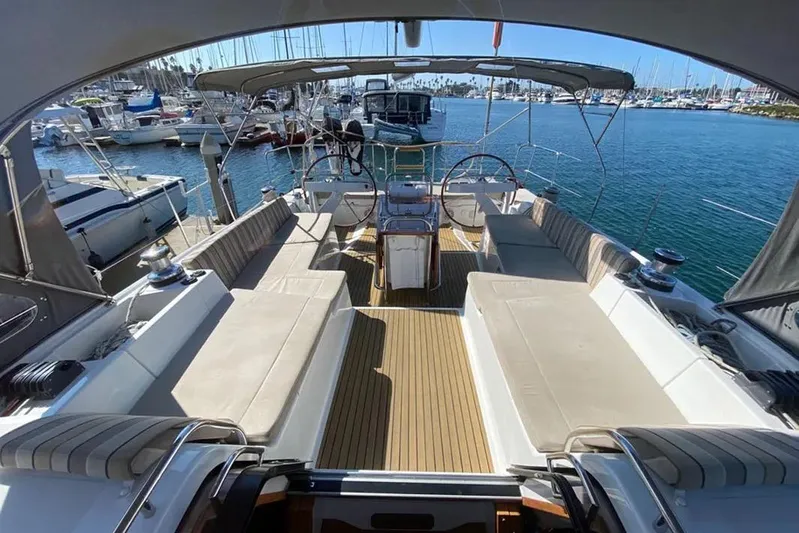 Motu Yacht Photos Pics Luxurious 2013 Jeanneau 57 yacht interior with spacious seating and elegant design in a marina.