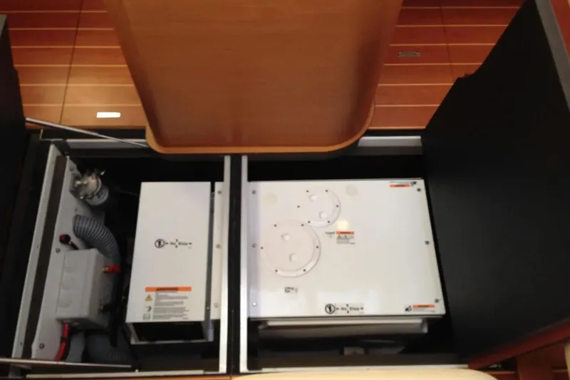 Motu Yacht Photos Pics Engine compartment of a 2013 Jeanneau 57 yacht, showcasing mechanical components.