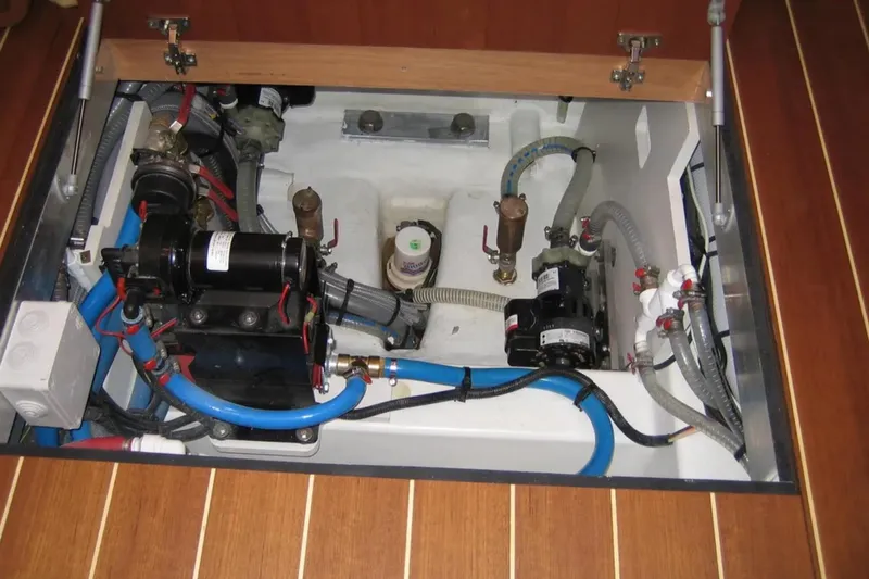 Motu Yacht Photos Pics Engine compartment of a 2013 Jeanneau 57 yacht, showcasing mechanical components and wiring.