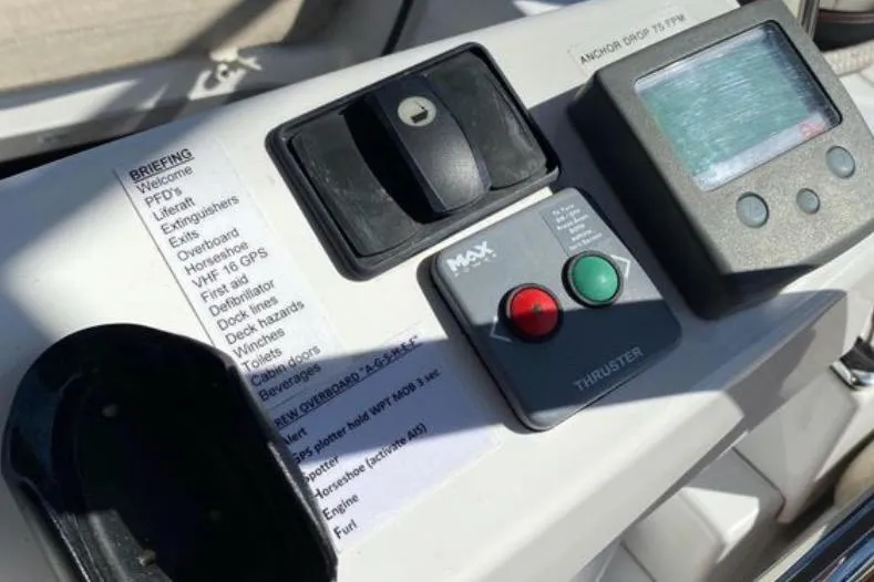 Motu Yacht Photos Pics Control panel of a 2013 Jeanneau 57 yacht with navigation and thruster controls.