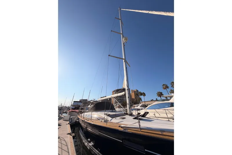 Motu Yacht Photos Pics 2013 Jeanneau 57 yacht docked under clear blue sky.